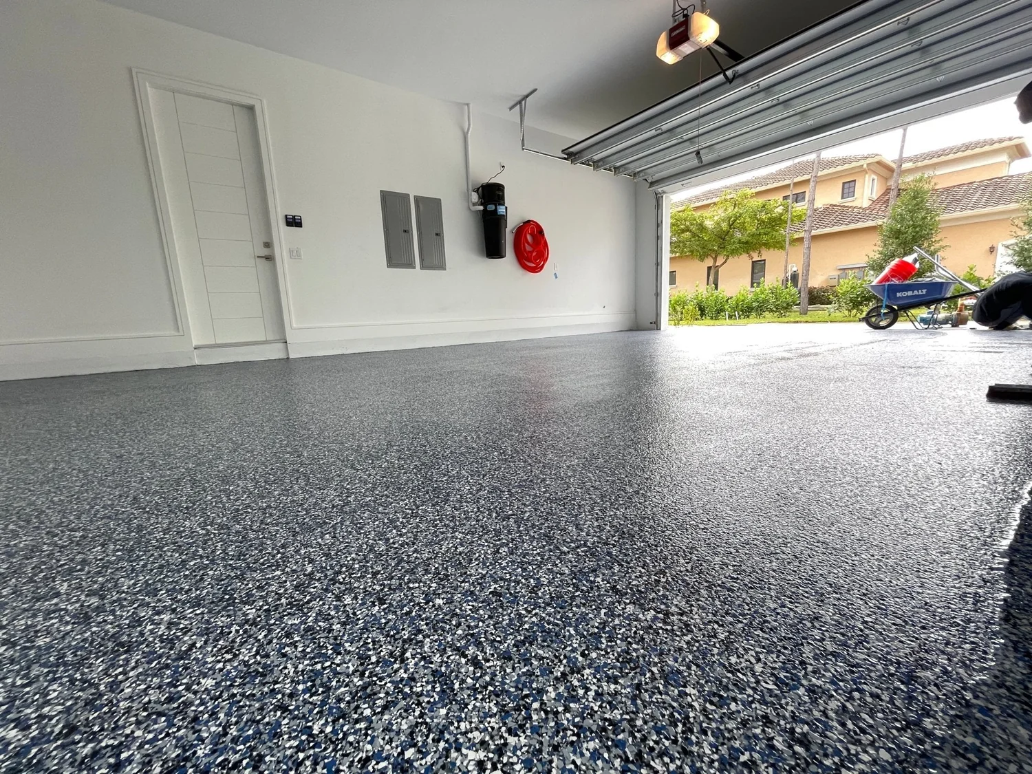 Blue and grey flake epoxy garage floor with a satin finish