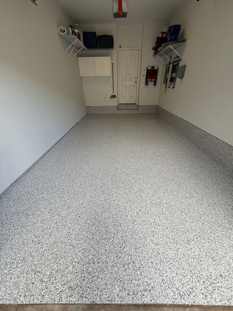 Blue, black and white flake epoxy garage floor with coved base